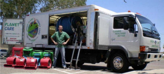 Bryan with carpet cleaning truck and steam cleaning equipment.